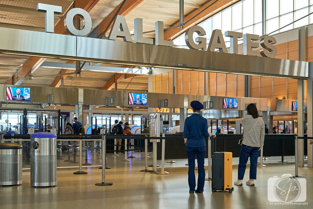 Andi at the RDU airport with her LEVEL8 Voyageur Suitcase
