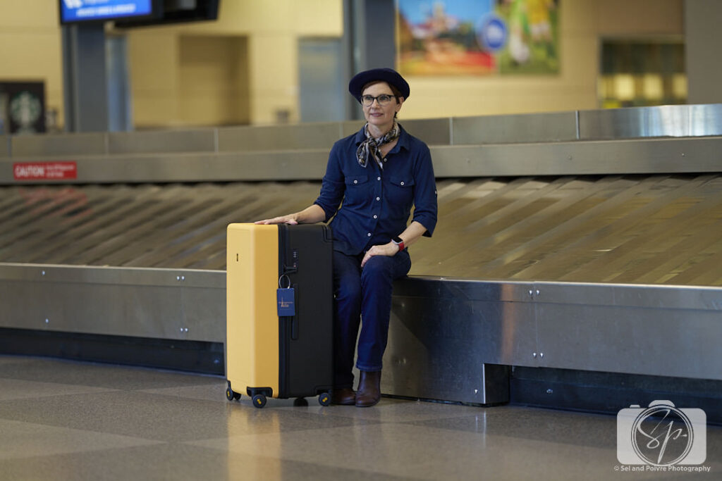 Andi at the RDU airport with her LEVEL8 Voyageur Suitcase