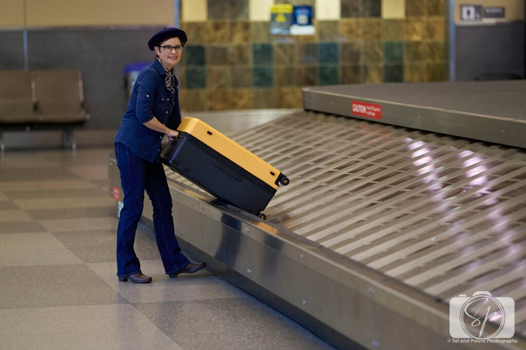 Andi at the RDU airport with her LEVEL8 Voyageur Suitcase