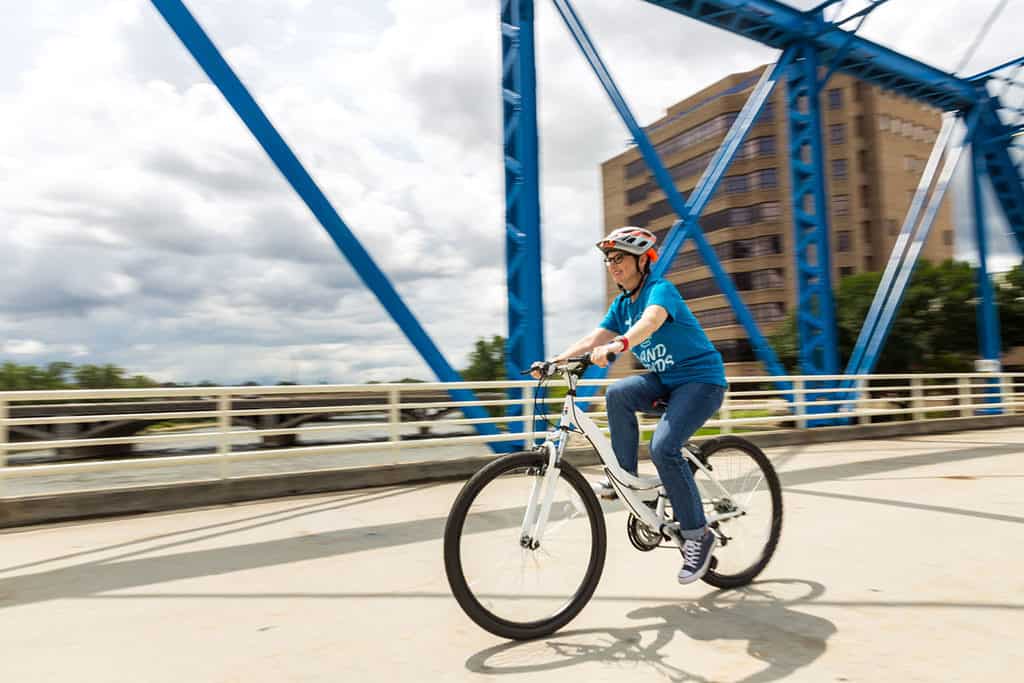 Andi Biking on Blue Bridge Grand Rapids_Photo Credit- Emily Sierra