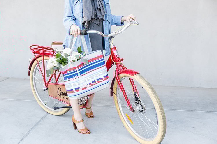 Girl on Bike with Paris Bag