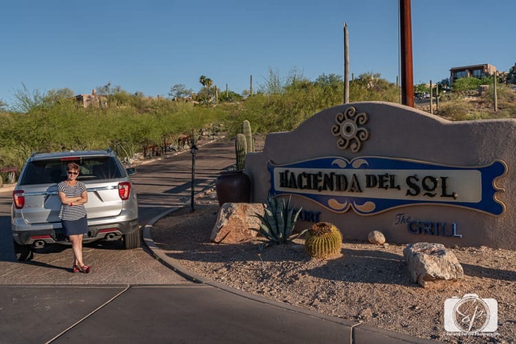 Andi in front of Hacienda del Sol sign in Tucson hero