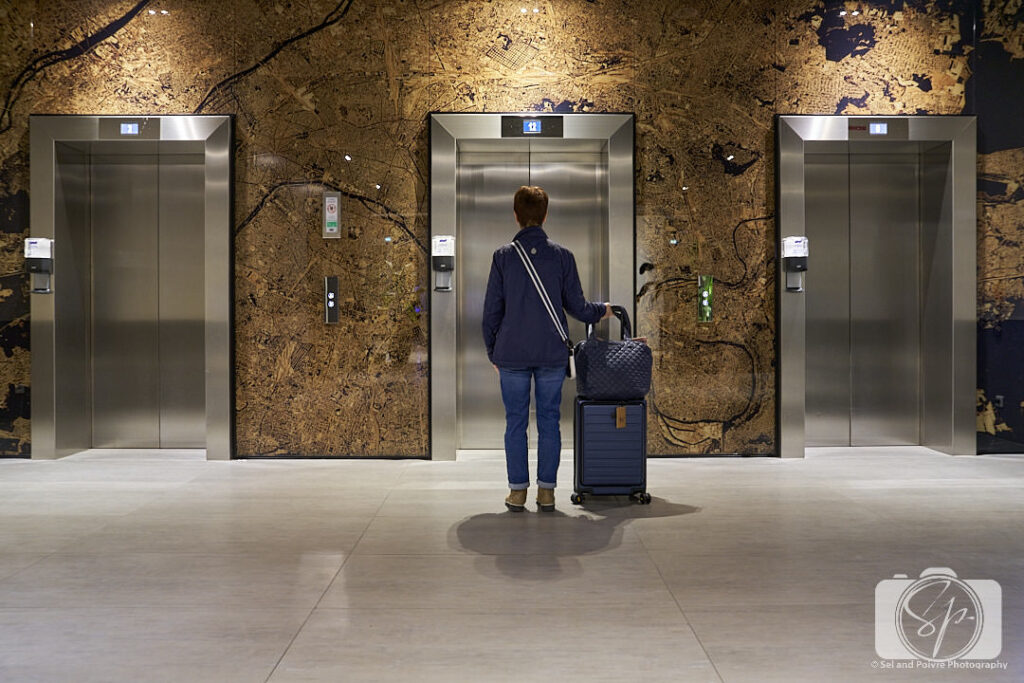 At the elevator of my Paris Hotel with LEVEL8 Road Runner Suitcase and MZ Wallace bag