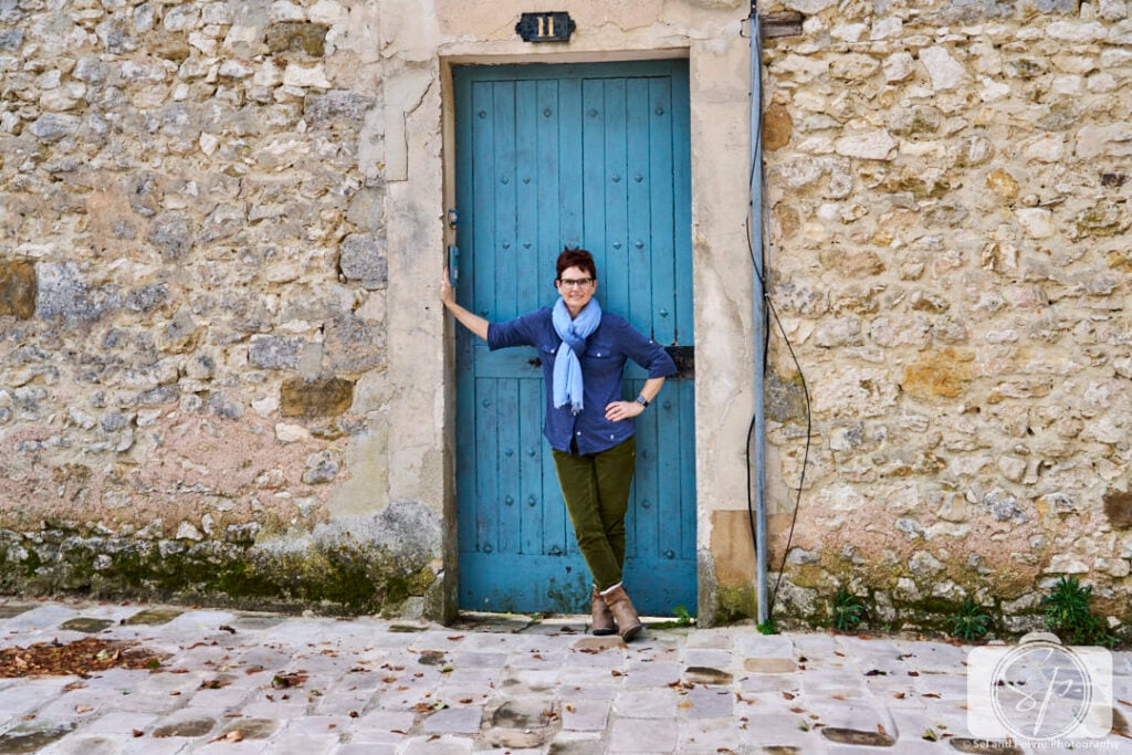 woman standing by a blue door