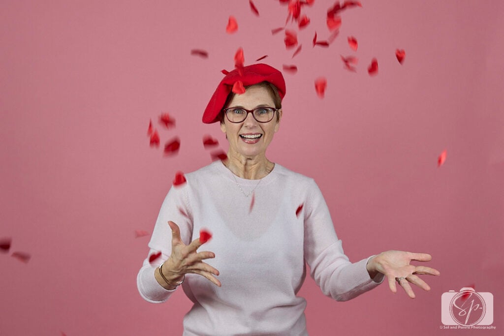 Andi in Quince sweater and beret throwing confetti