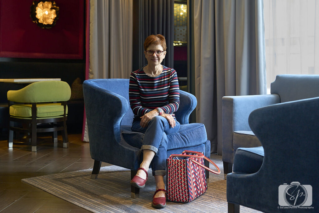 Andi in the living room of the Kimpton Cardinal Hotel with Jambu Dandelion shoes