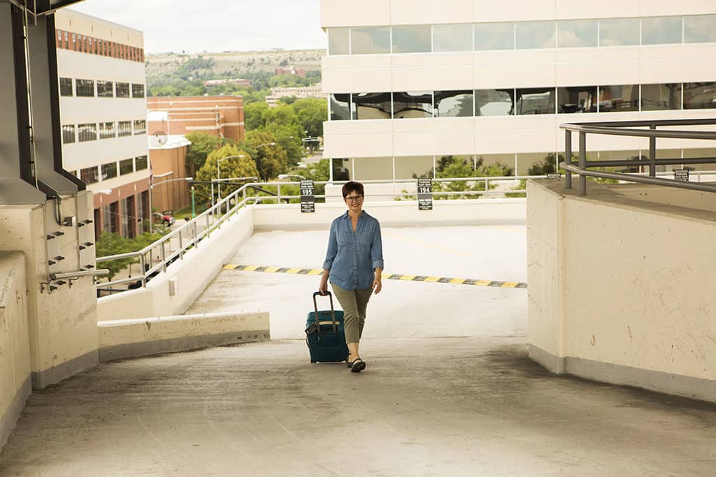 Andi Parking Garage with her suitcase
