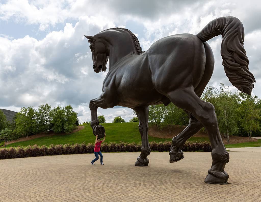 Andi under the horse in the Meijer Sculpture Gardens Grand Rapids_Photo credit- Emily Sierra