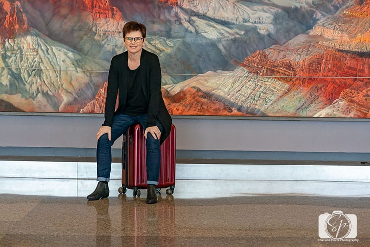 Andi with her Delsey Paris Helium Titanium hardside luggage set carry on hero