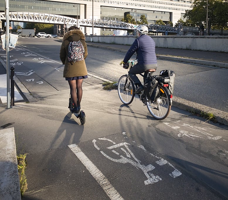 Bikes and scooter in a bike path in Paris