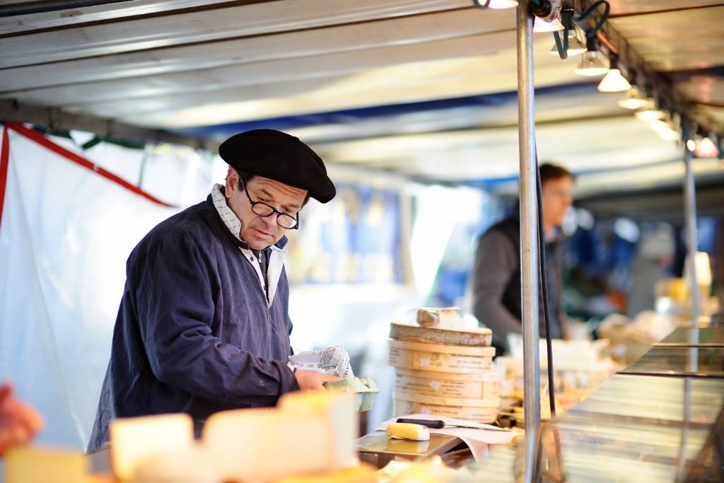 man at Cheese Stand at French Market