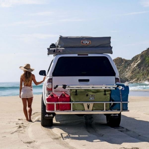 truck on beach with cargo rack and tent