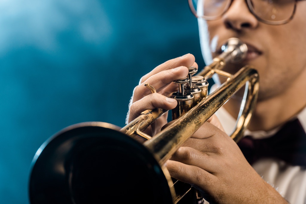 Cropped shot of male musician playing on trumpet