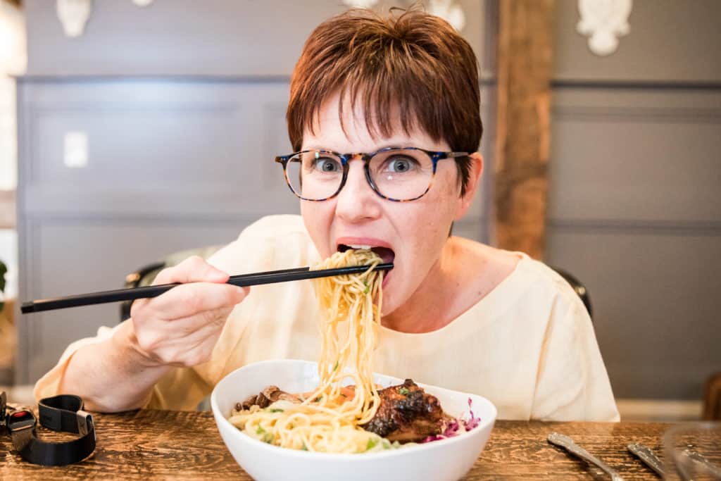 Things to do in Billings Montana: Eating noodles in my linen notched button pullover in sunshine yellow at the Fieldhouse restaurant in Billings Montana