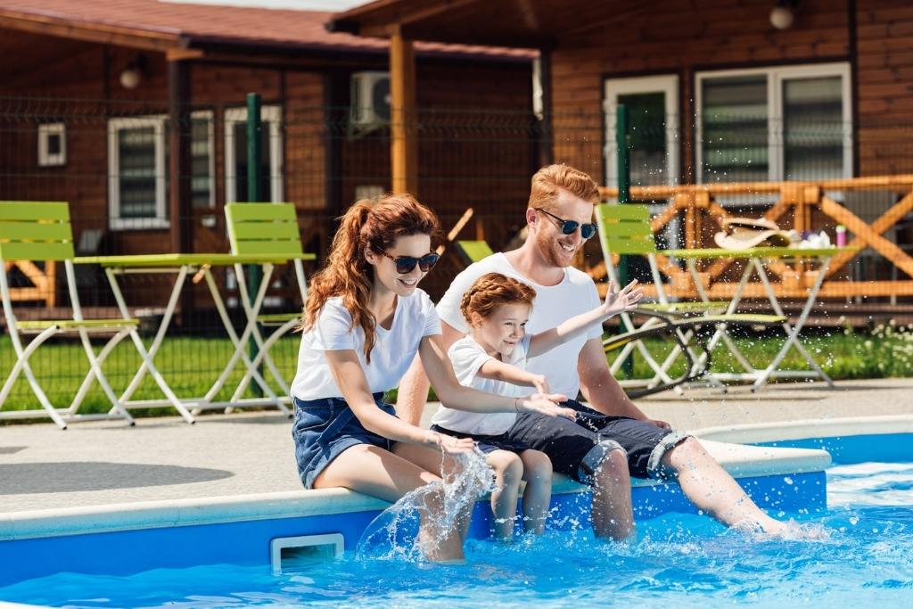 family with feet in pool water