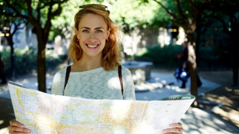 Female traveler exploring location map