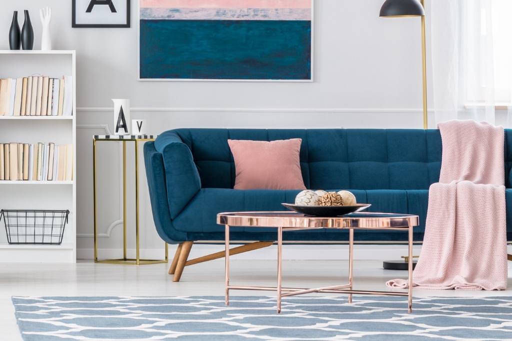 teal couch with pink pillow and blanket