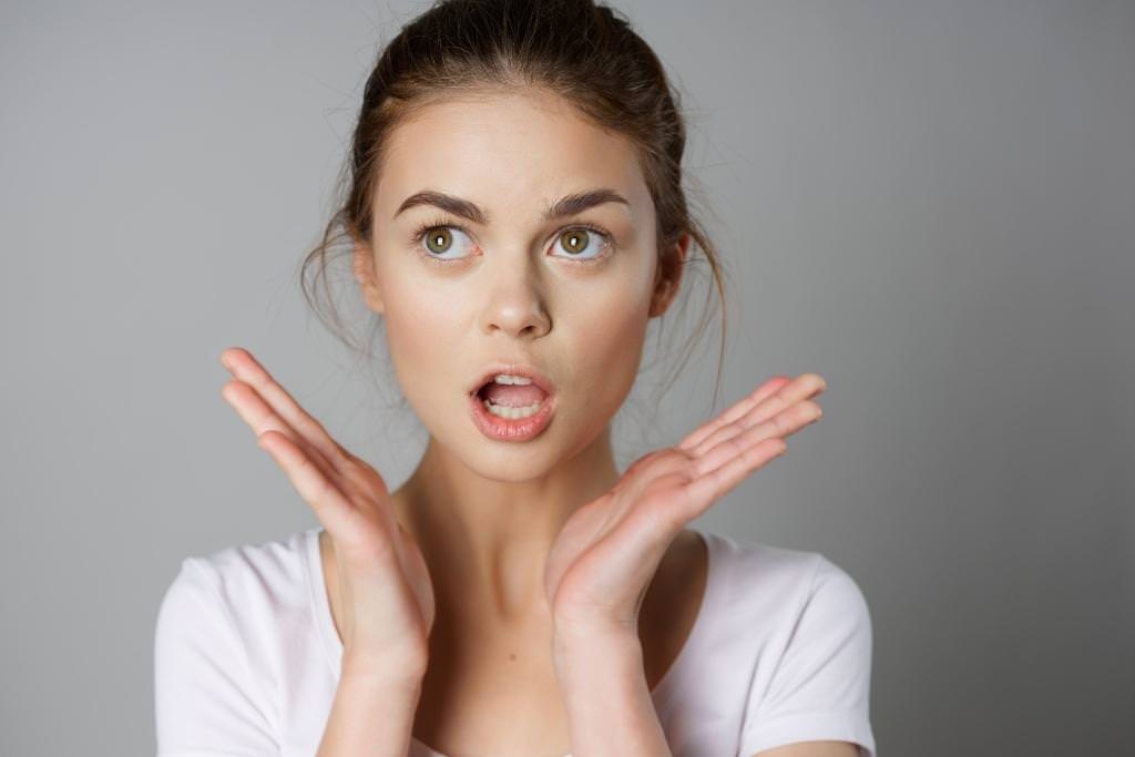 girl with minimal make-up with surprised look on her face