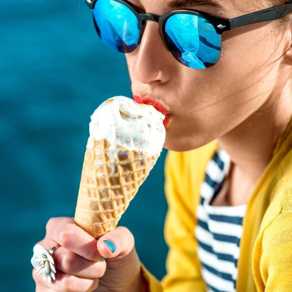 girl eating ice cream by pool