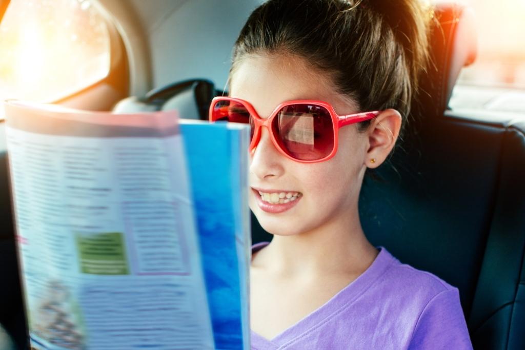 Girl reading in car