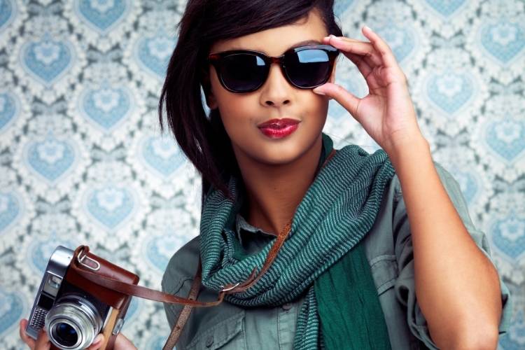 women in sunglasses with camera