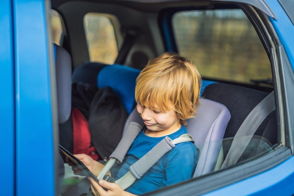 Kid with iPad in car
