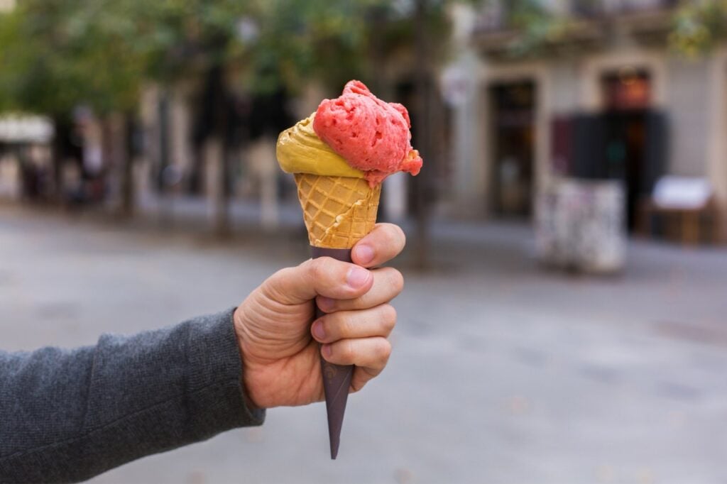 Man holding an ice cream in the street