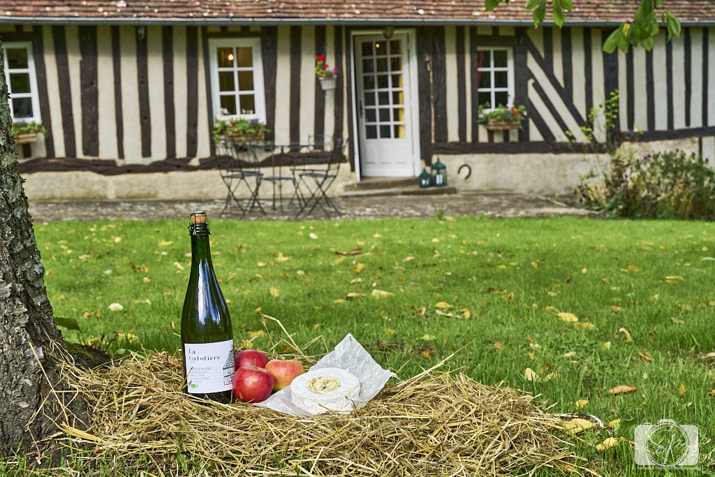 Pays D'Auge Normandy France Cider Bottle Apples and Camembert in front of Normand House