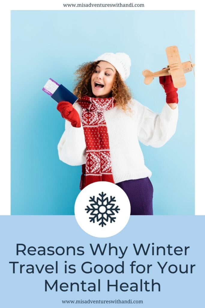 Excited young woman in hat and sweater holding passport and toy plane on blue
