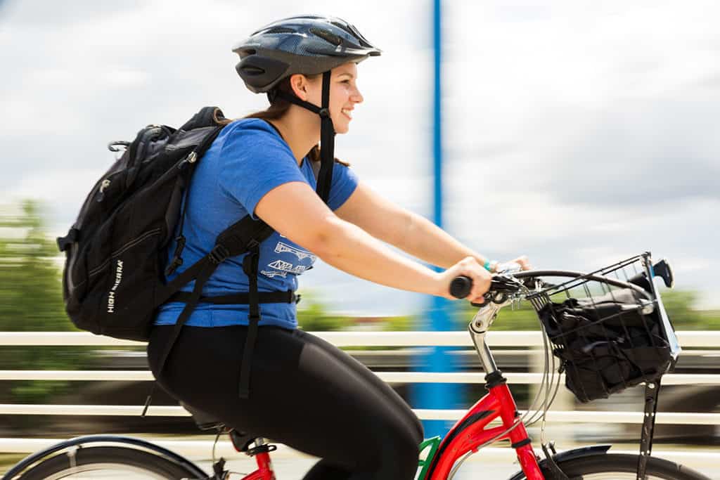 Stephanie Biking on Blue Bridge Grand Rapids_Photo Credit- Emily Sierra