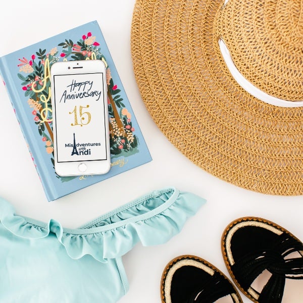 sunhat, sunglasses, swimming suit, sandals and a book