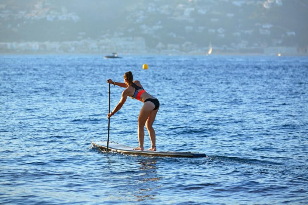 SUP Stand up Surf girl with paddle