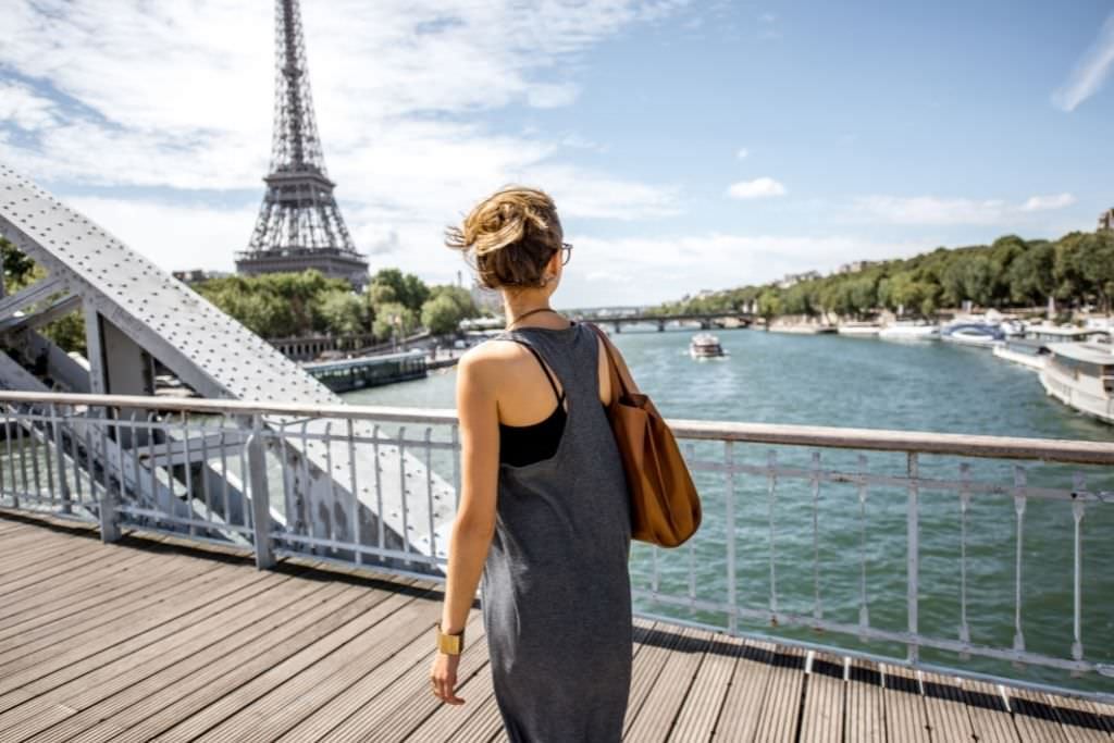girl walking on bridge in Paris