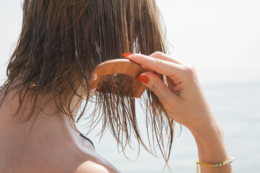 Woman combing hair on the beach