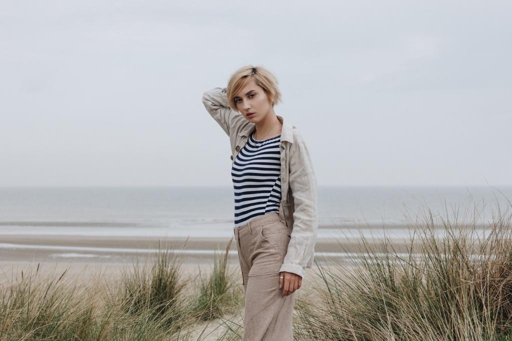 woman in blue and white striped shirt on the beach