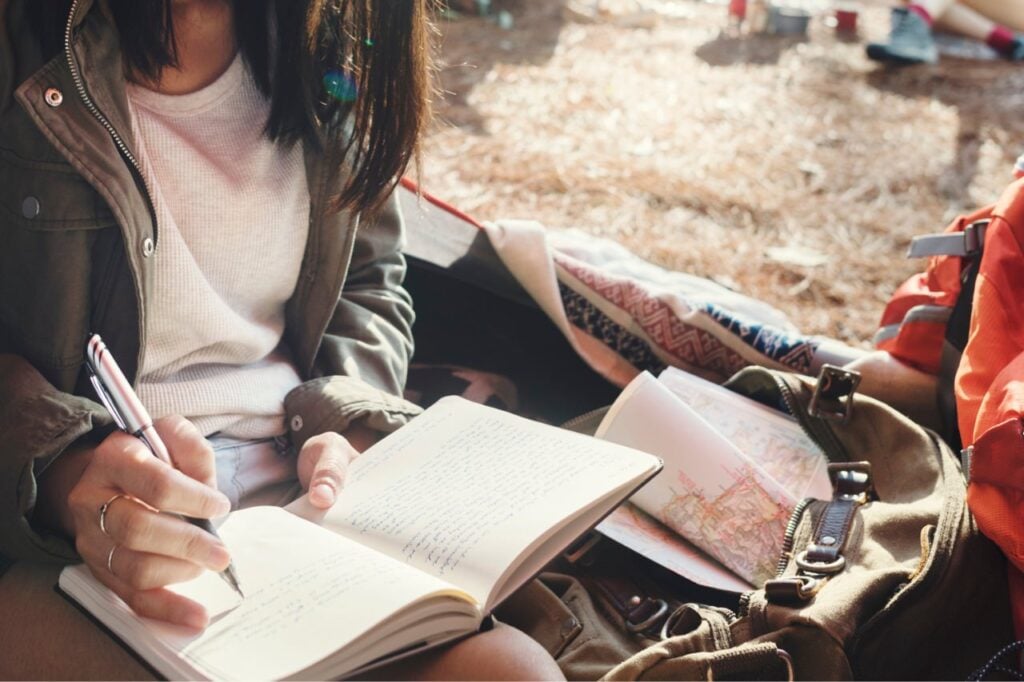 woman journaling while camping